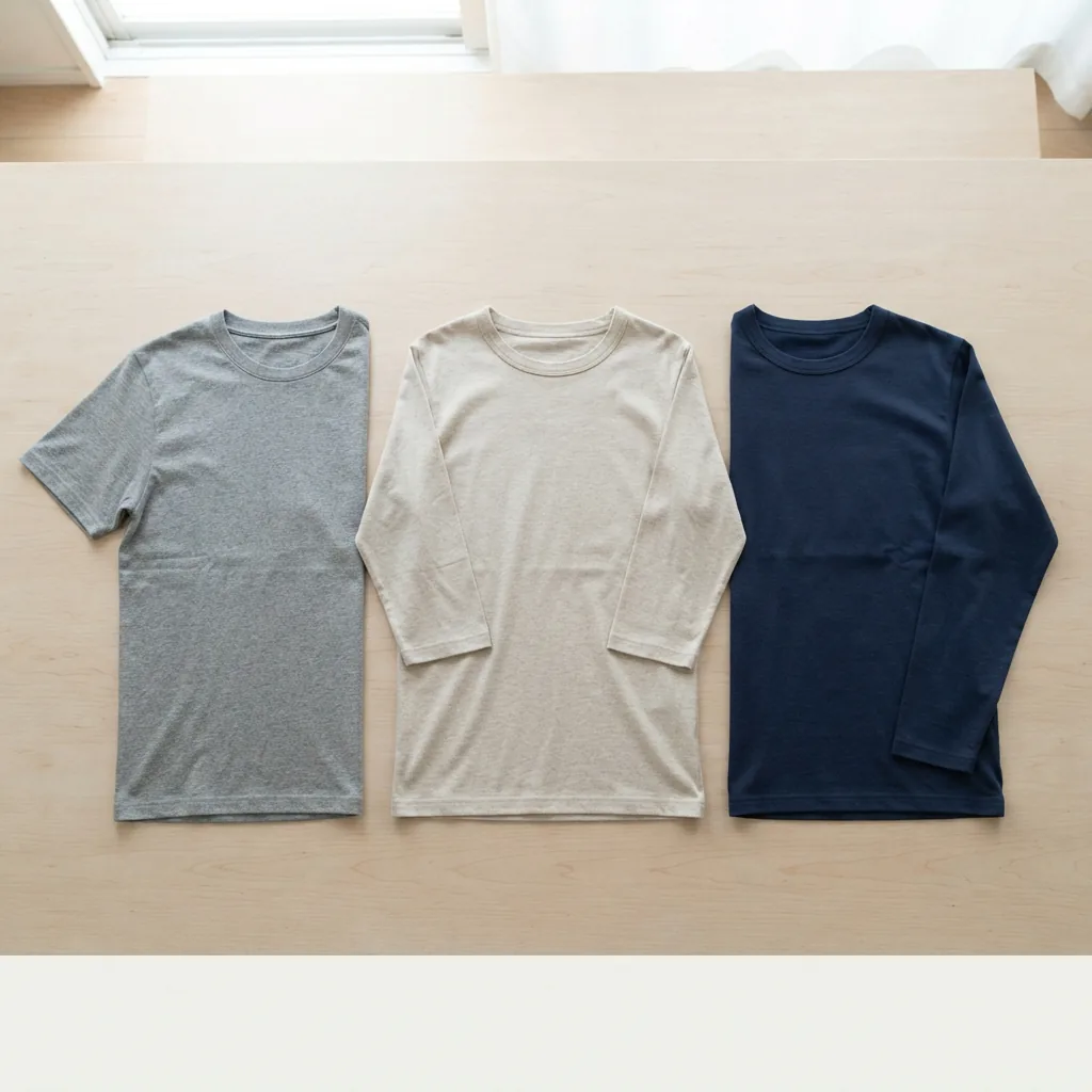 Shirts with short, three-quarter and long sleeves arranged in a row on a flat surface